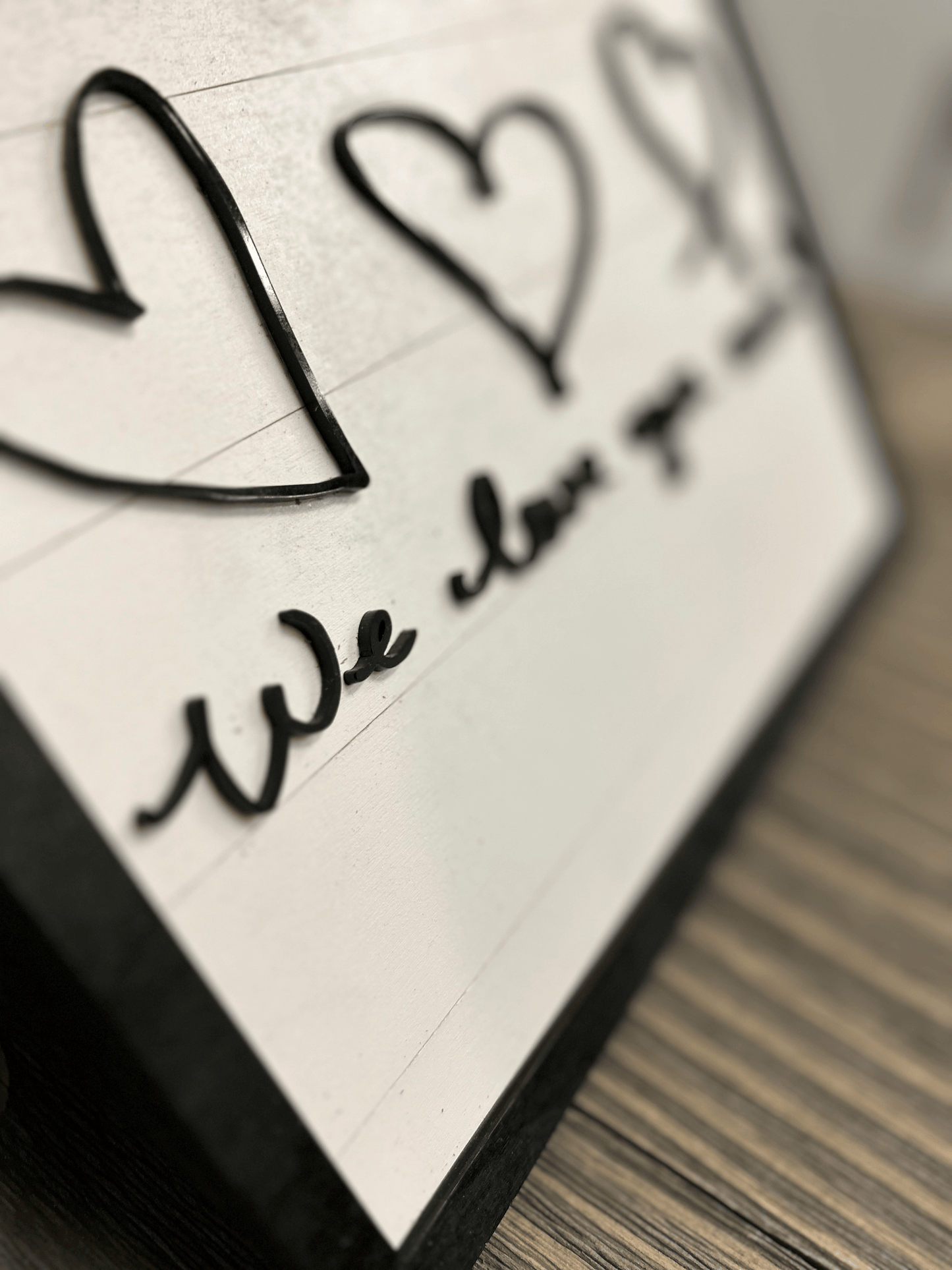 Hand-drawn signature with a sophisticated flourish, formed with acrylic on a light background