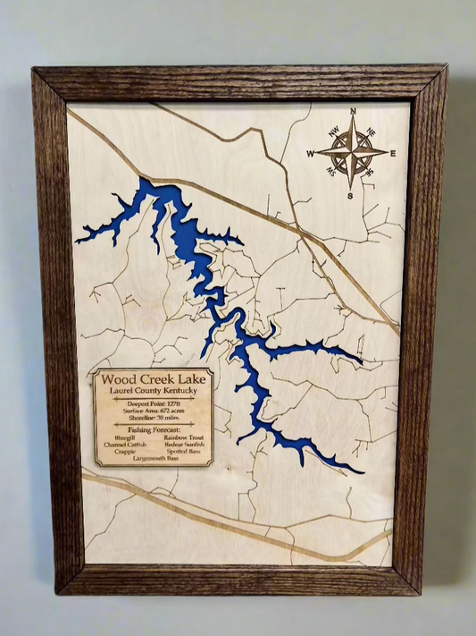 A wooden topographic map of Wood Creek Lake, Kentucky, framed in dark wood. The engraved plaque provides lake details, including depth, surface area, shoreline length, and fish species. The lake is represented in blue against a natural wood background.