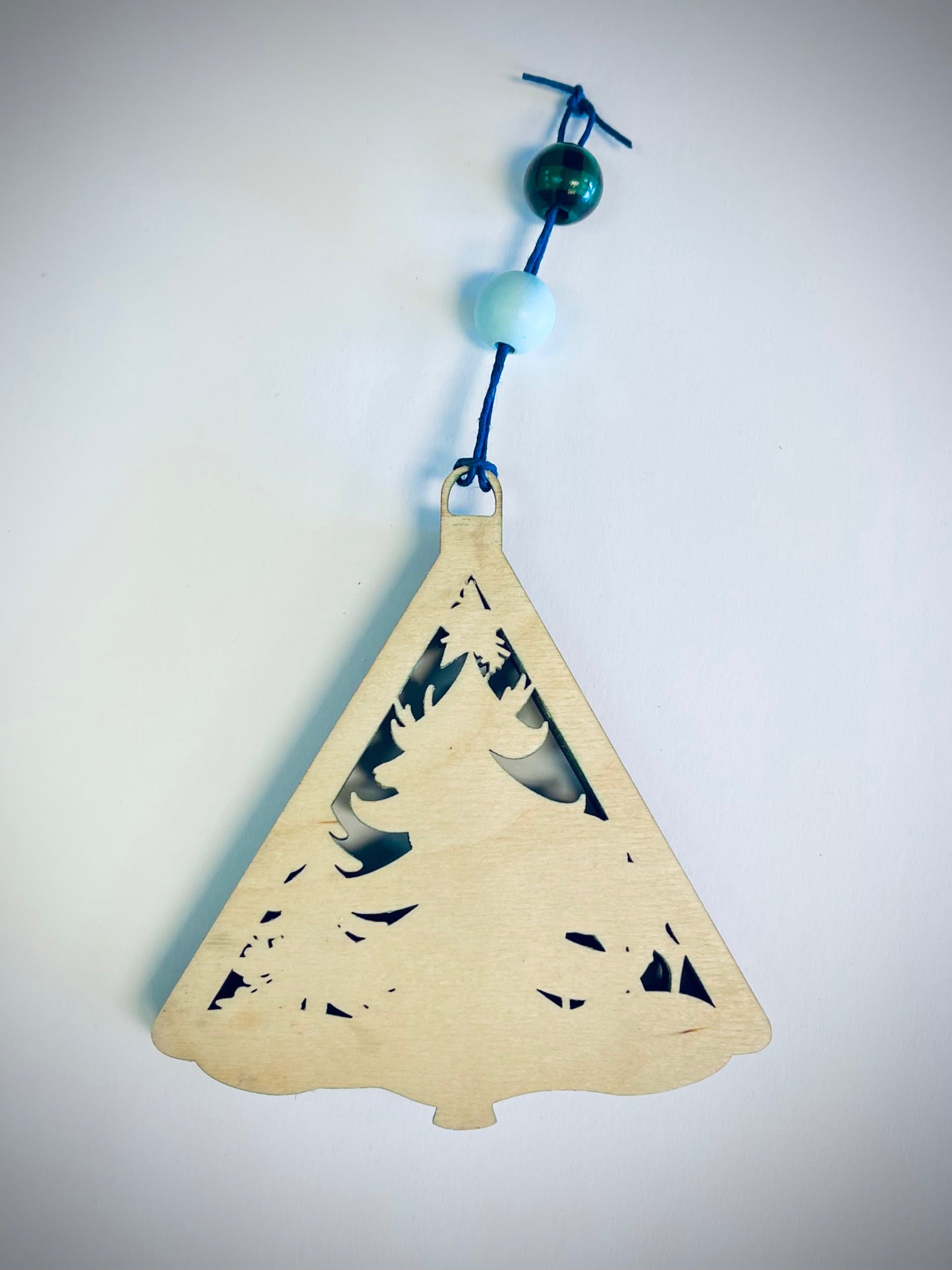Wooden Christmas tree ornament with deer cutout, blue string and decorative beads