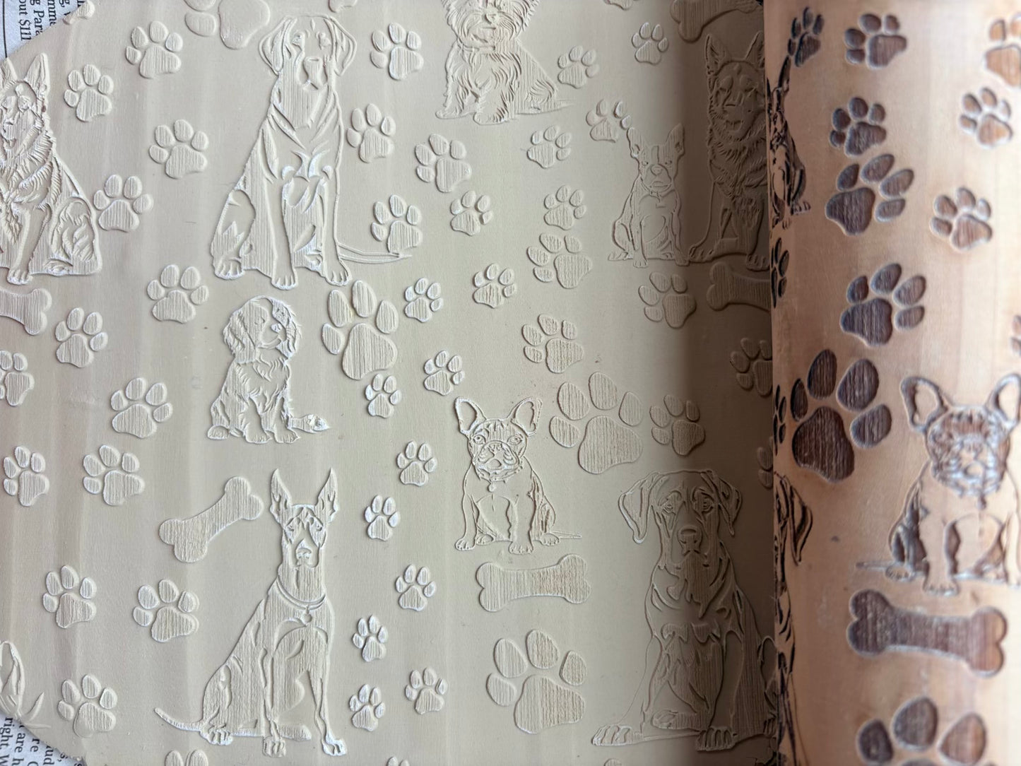 Custom engraved dog designs with paw prints and bones on wood