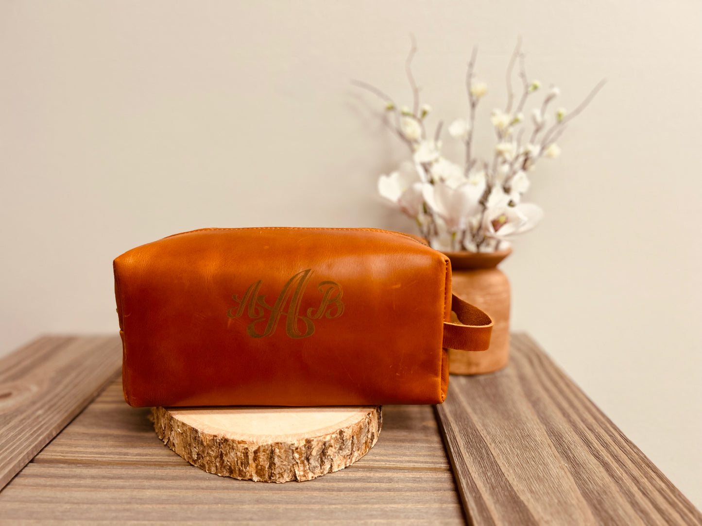 Spacious leather toiletry bag with a durable zipper closure, perfect for storing grooming essentials during travel.