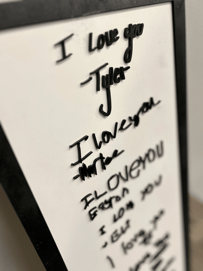 Elegant, free-flowing handwritten signature with connected cursive strokes in acrylic.