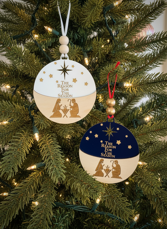 Nativity scene Christmas ornaments with 'The Reason for the Season' text on a decorated tree.