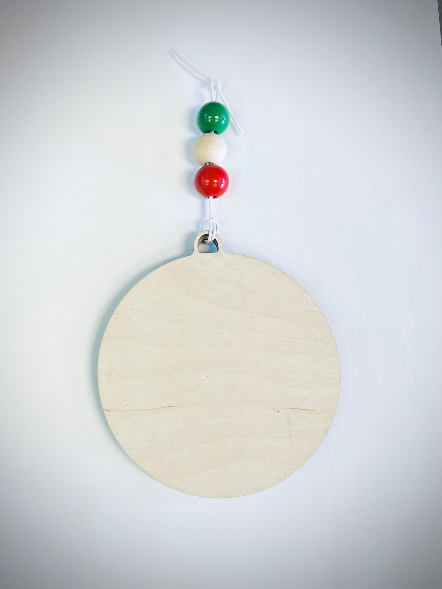 Blank wooden ornament with red, white, and green beads on a white background
