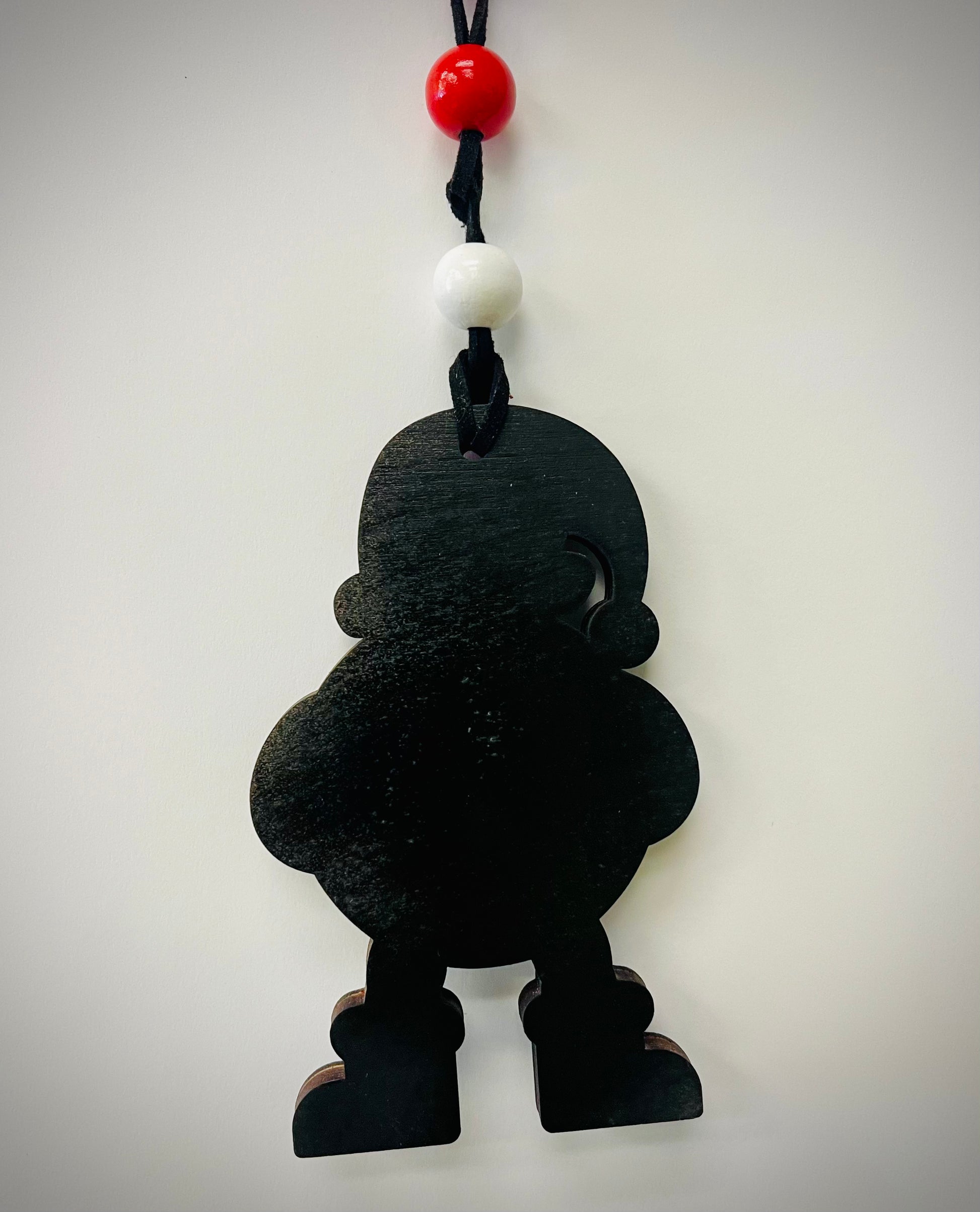Black wooden Santa Cam ornament with red and white beads on a black cord, against a white background.