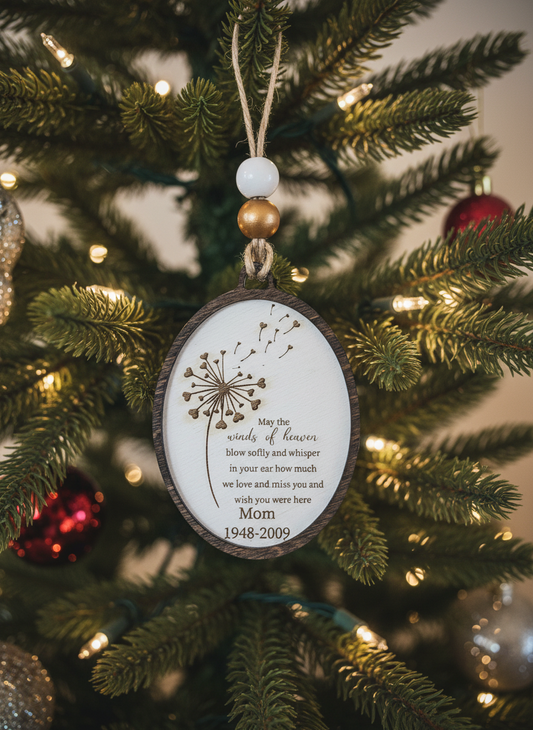 Dandelion memorial ornament hanging on Christmas tree with lights and beaded string