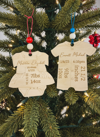 Personalized wooden baby onesie Christmas ornaments on a decorated tree
