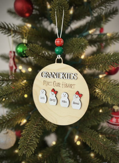 Grandkids melt our heart ornament with snowmen names on Christmas tree