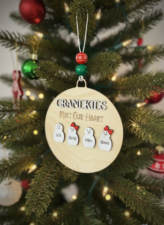Grandkids melt our heart ornament with snowmen names on Christmas tree