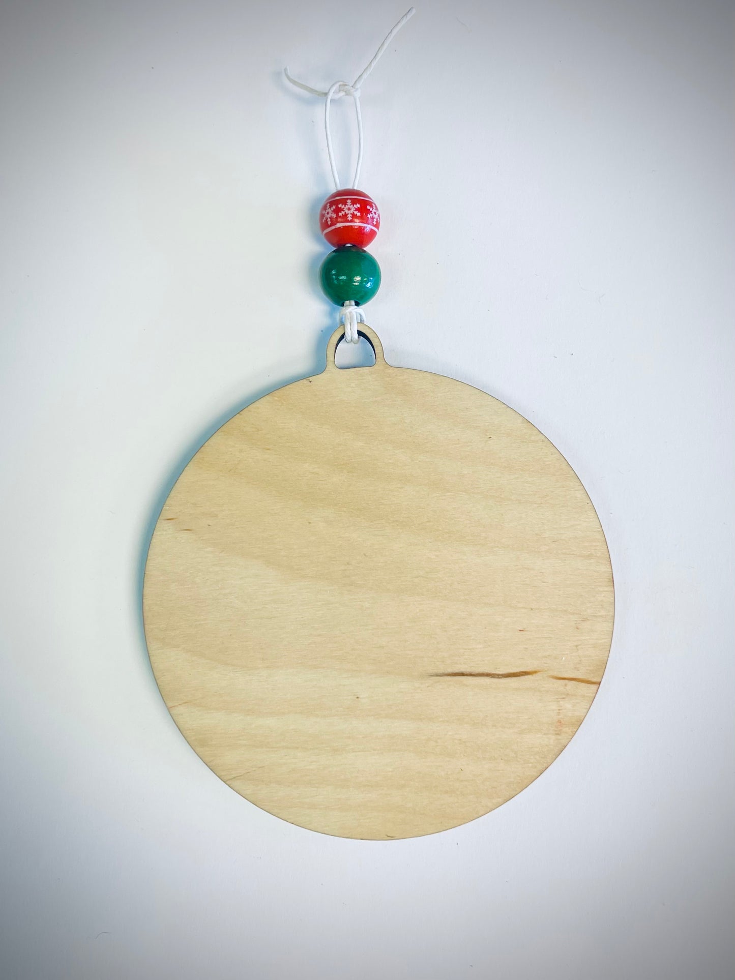 Blank round wood Christmas ornament with red and green beads and string hanger