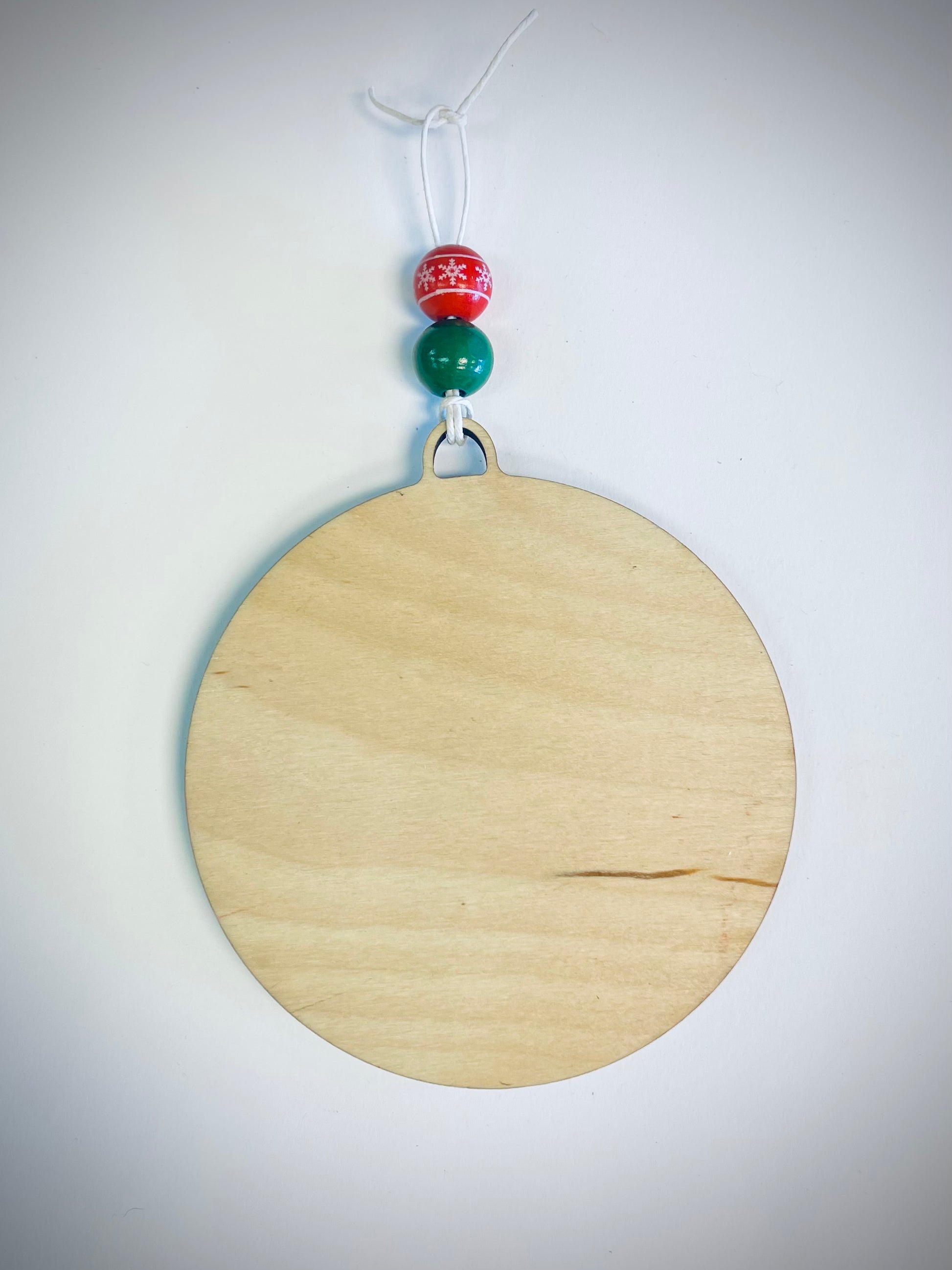 Blank round wood Christmas ornament with red and green beads and string hanger