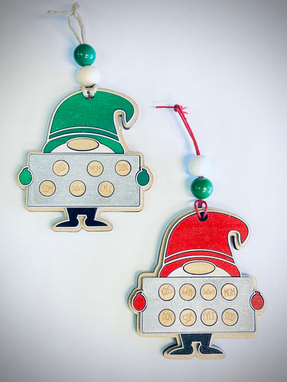 Two gnome Christmas ornaments with family cookie names, one green, one red hat.
