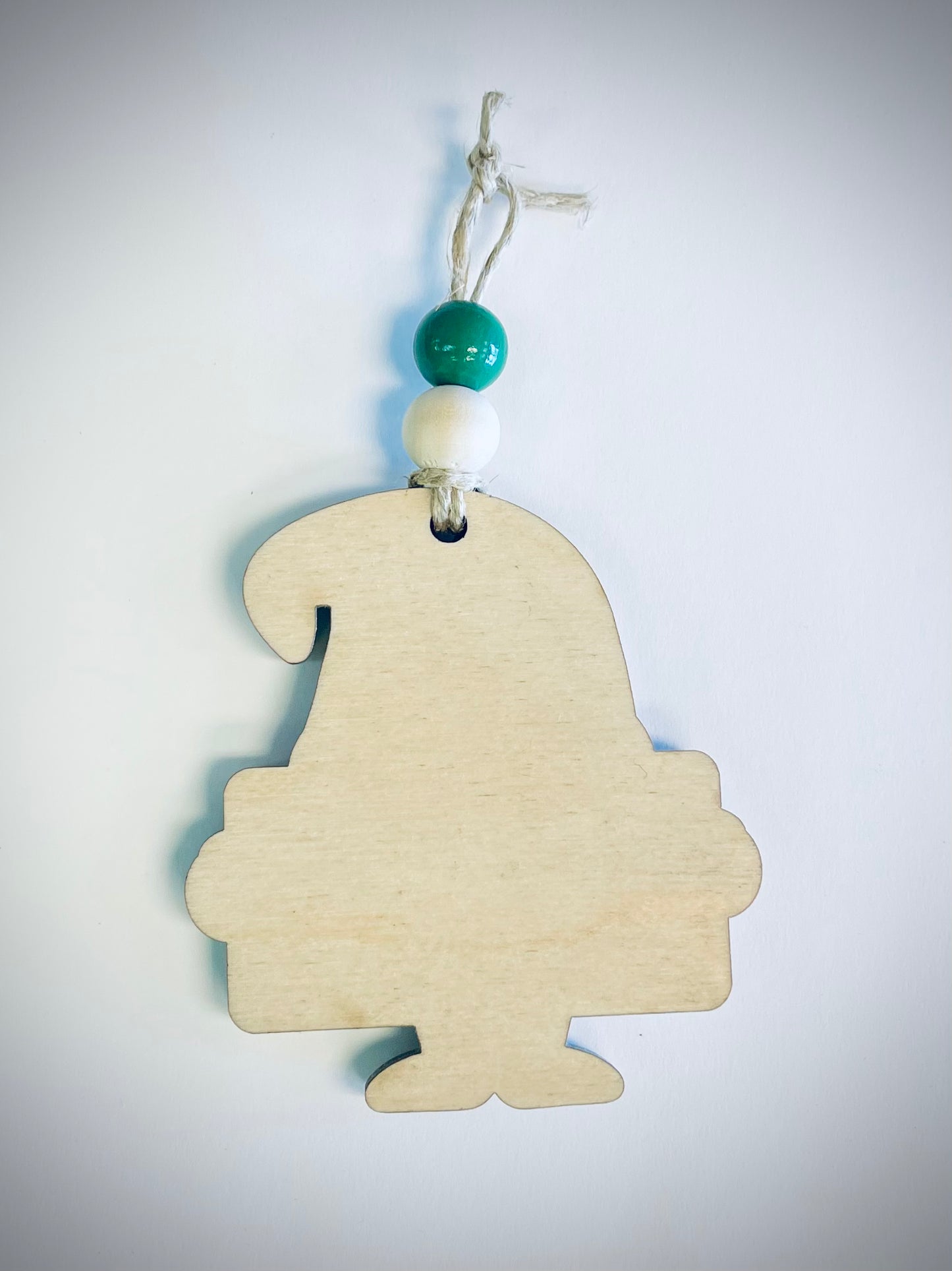 Unpainted wooden gnome ornament with green and white beads on a string