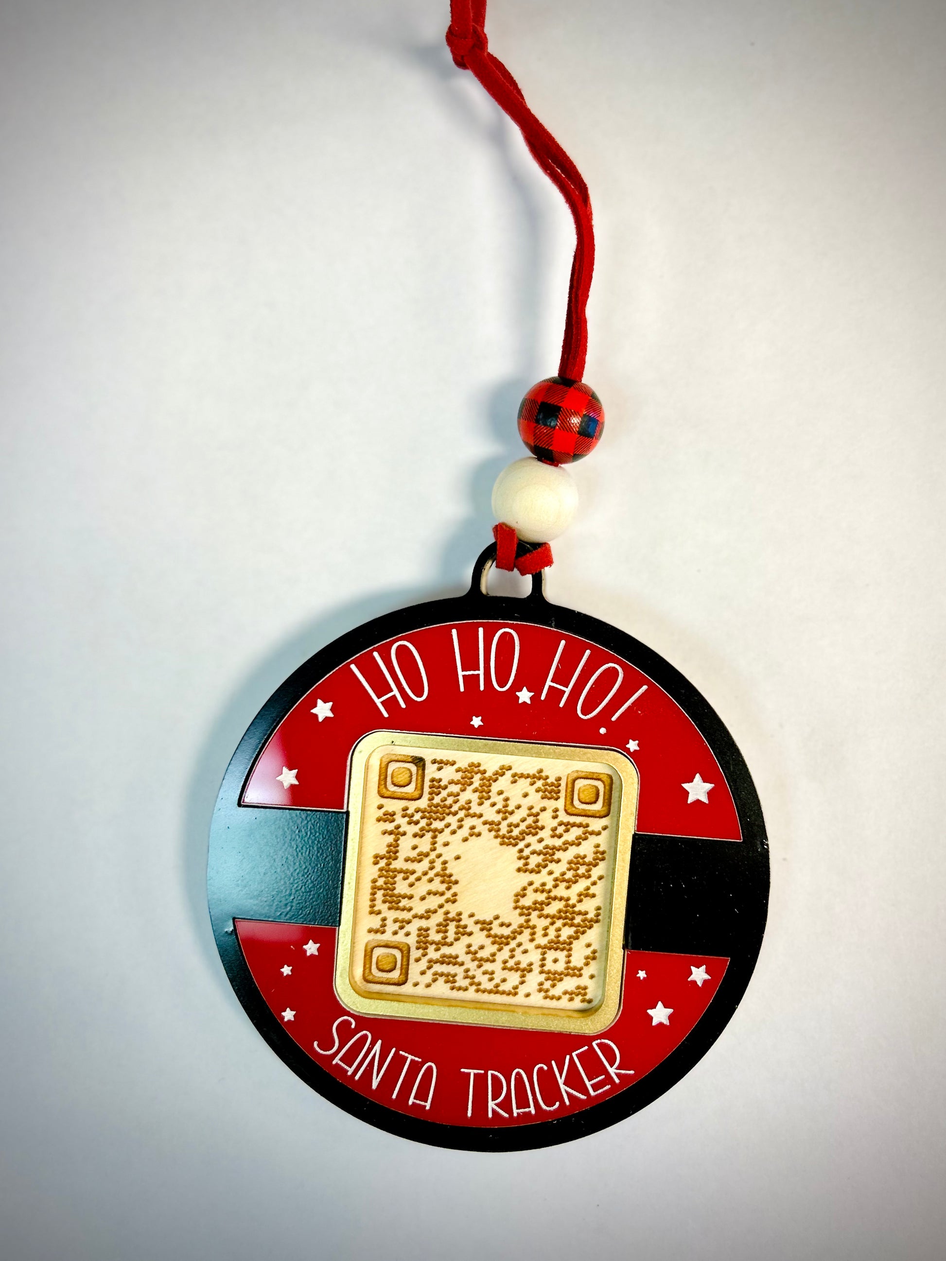 Santa Tracker ornament with QR code, festive beads, red ribbon, and star accents