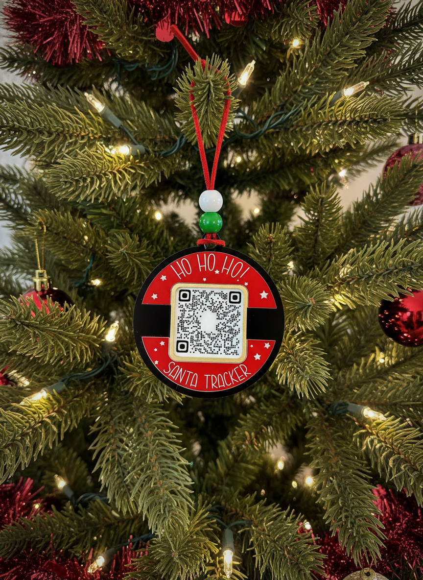 Santa Tracker QR code ornament hanging on a decorated Christmas tree