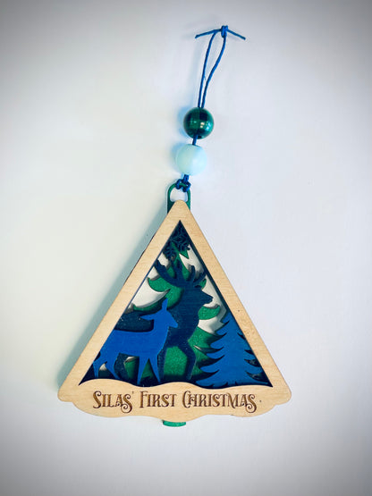 Triangular wood ornament with blue deer, tree, beads, Silas' First Christmas text