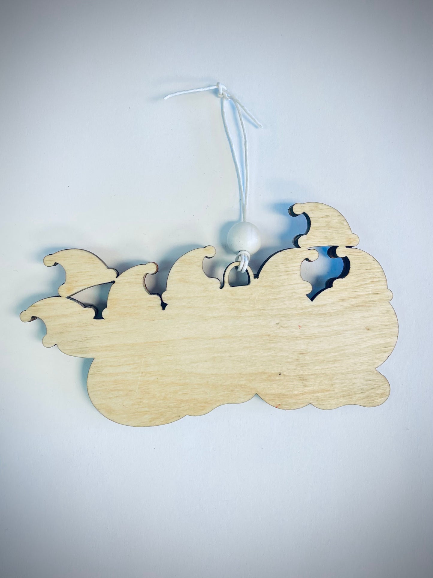 Blank wooden family hats ornament with white string and bead on white background