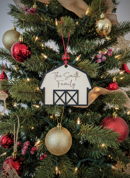 Farmhouse barn ornament with 'The Smith Family' on Christmas tree with red and gold baubles