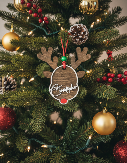 Personalized reindeer ornament on Christmas tree with gold and red baubles, pine cones