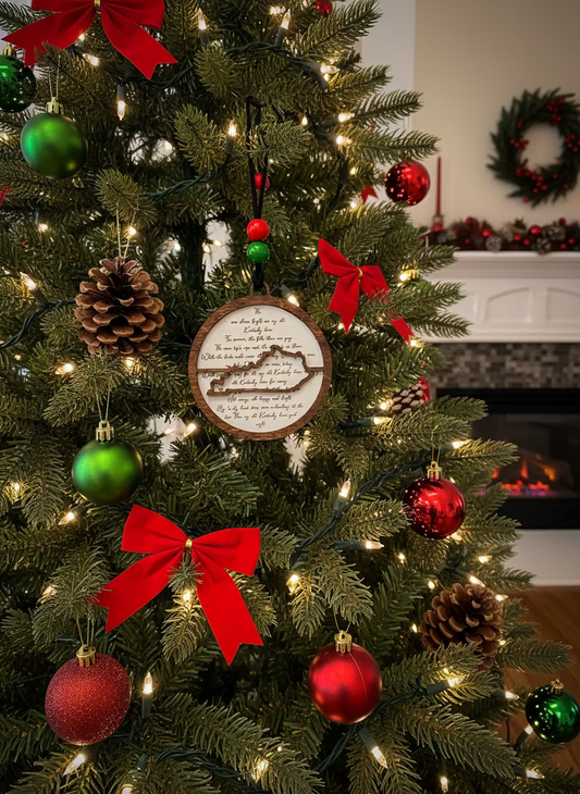 Christmas tree with My Old Kentucky Home wood ornament, red bows, pinecones, and ball ornaments