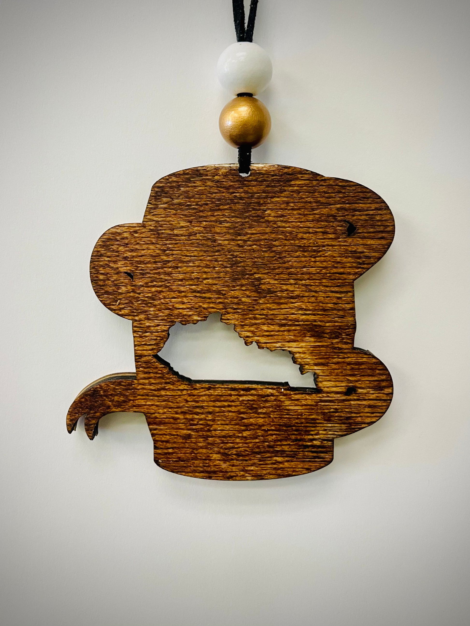 Wood bourbon barrel ornament with Kentucky cutout, white and gold beads, on white background