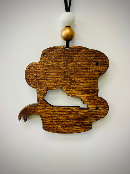 Wood bourbon barrel ornament with Kentucky cutout, white and gold beads, on white background