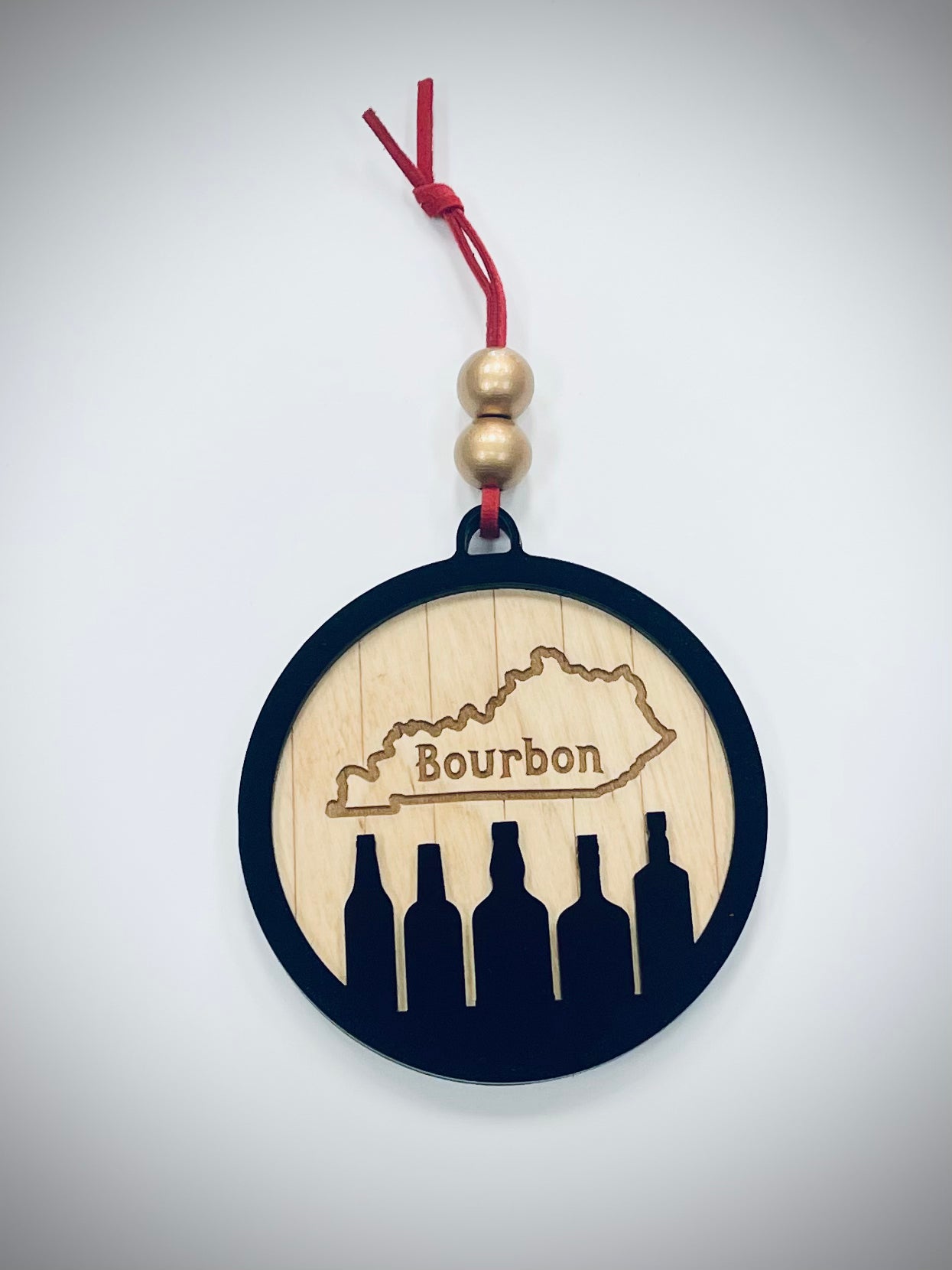 Kentucky bourbon ornament with bottle silhouettes, wood cutout, red string and gold beads