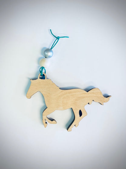 Layered wood horse ornament with blue and white beads on a teal string