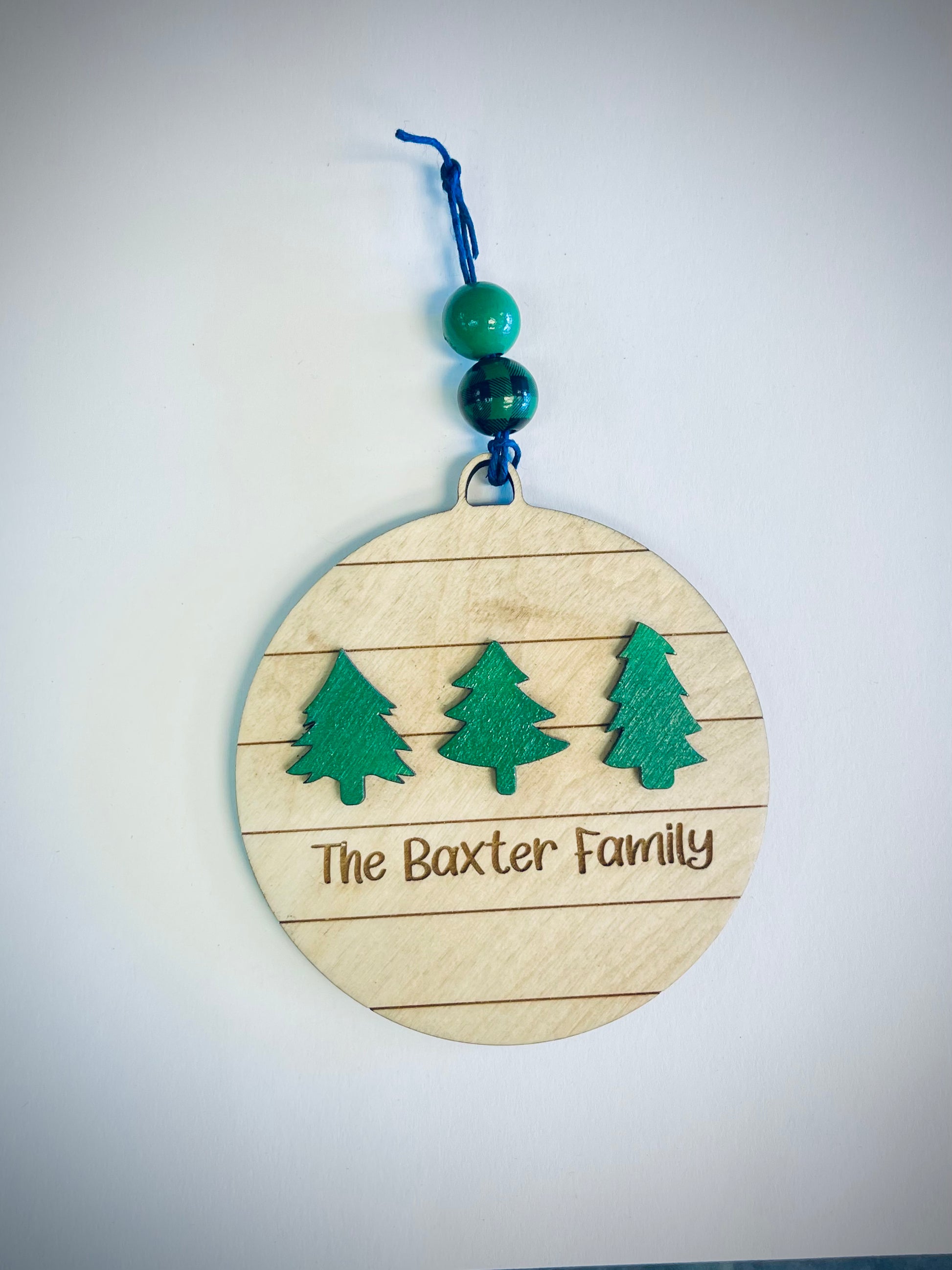 Personalized wood Christmas ornament with three green trees and decorative beads