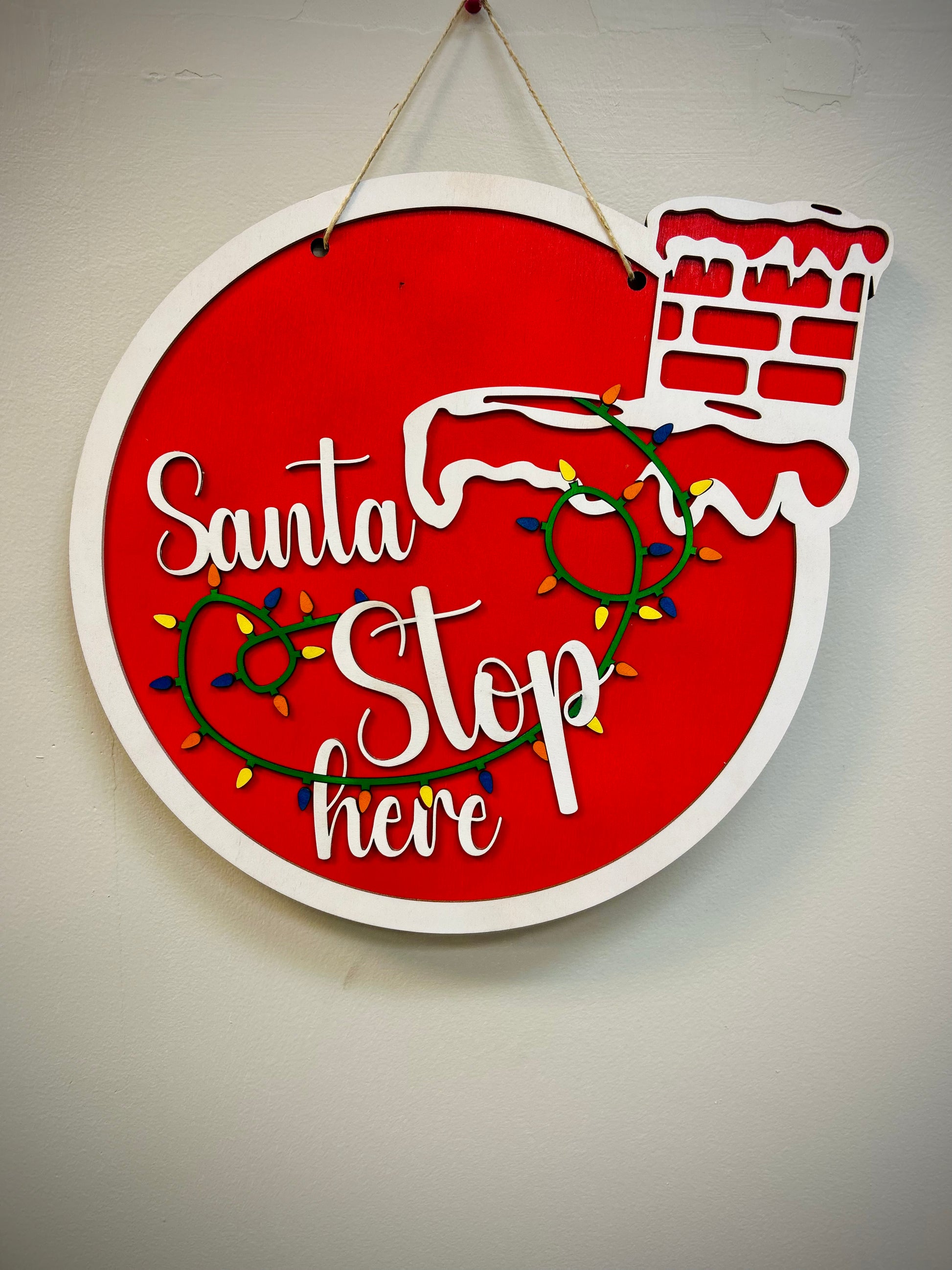 Red Santa Stop Here door hanger with chimney, lights, and white text for Christmas decor