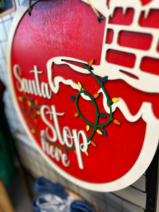 Red wooden Santa Stop Here door hanger with Christmas lights decoration