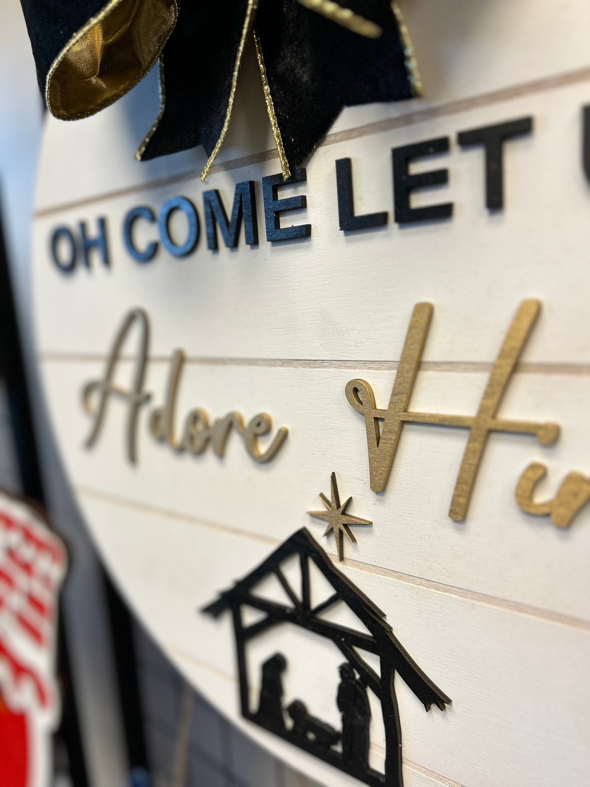 Oh Come Let Us Adore Him Christmas door hanger with nativity scene and bow decoration