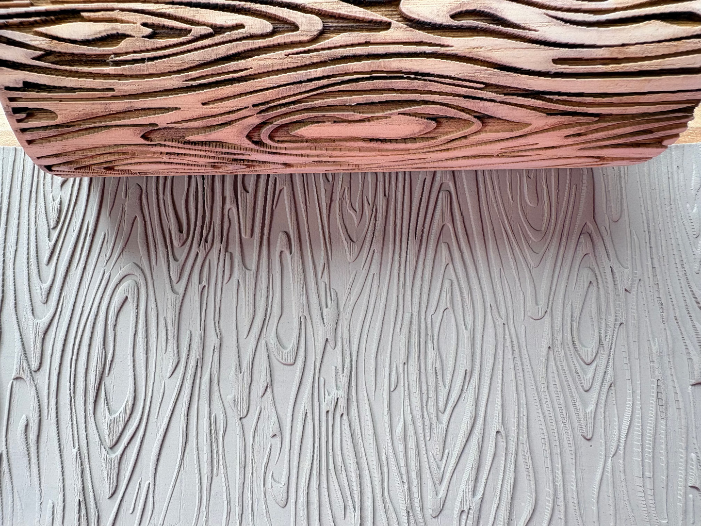 Close-up of laser-engraved wood grain patterns on custom wooden decor, showcasing detailed texture and craftsmanship.