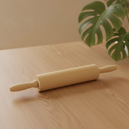 Custom engraved wooden rolling pin on light wood table with monstera leaf